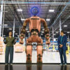 Boston Dynamics Atlas humanoid robot standing in Hyundai Motor Group factory environment, representing the company's $26 billion physical AI and robotics investment strategy