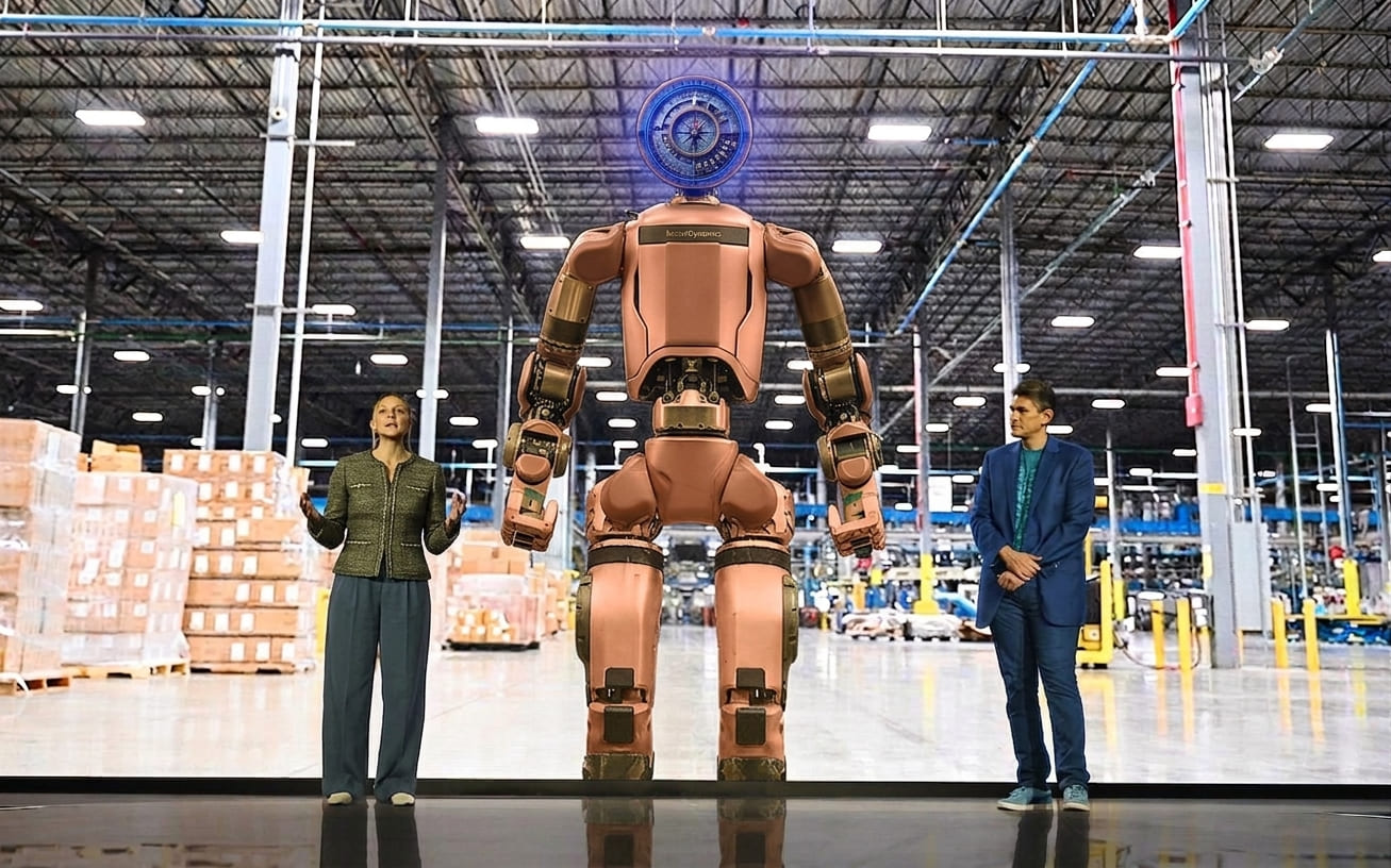 Boston Dynamics Atlas humanoid robot standing in Hyundai Motor Group factory environment, representing the company's $26 billion physical AI and robotics investment strategy